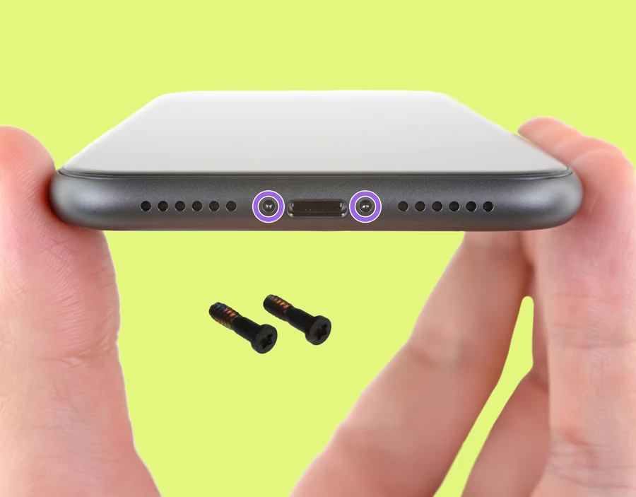 Image of the bottom edge of an iPhone showing pentalobe screws.
