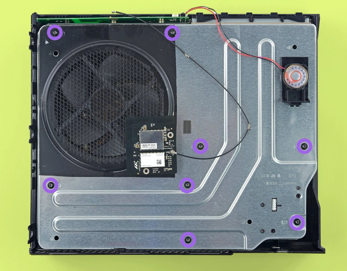 Xbox One internal chassis with the eight black screws highlighted