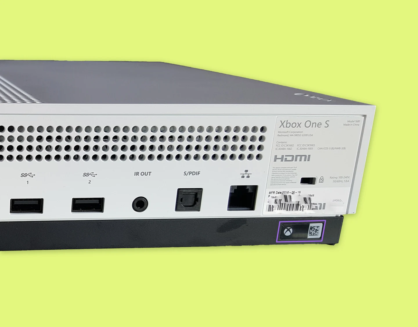 The back panel of the Xbox One S with the warranty sticker highlighted