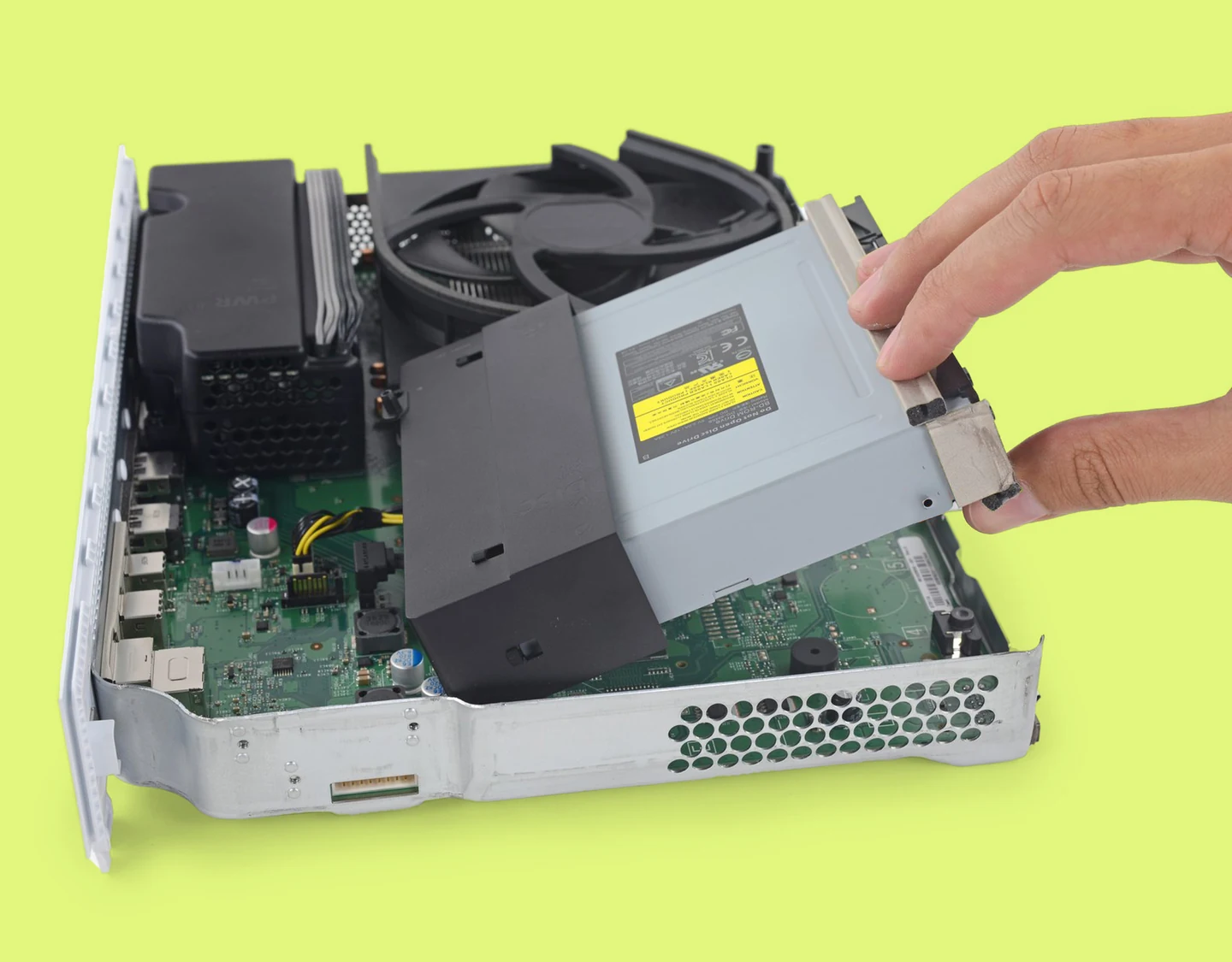 Xbox One S internal components with the hard drive, disk drive, power supply unit, and cooling fan visible