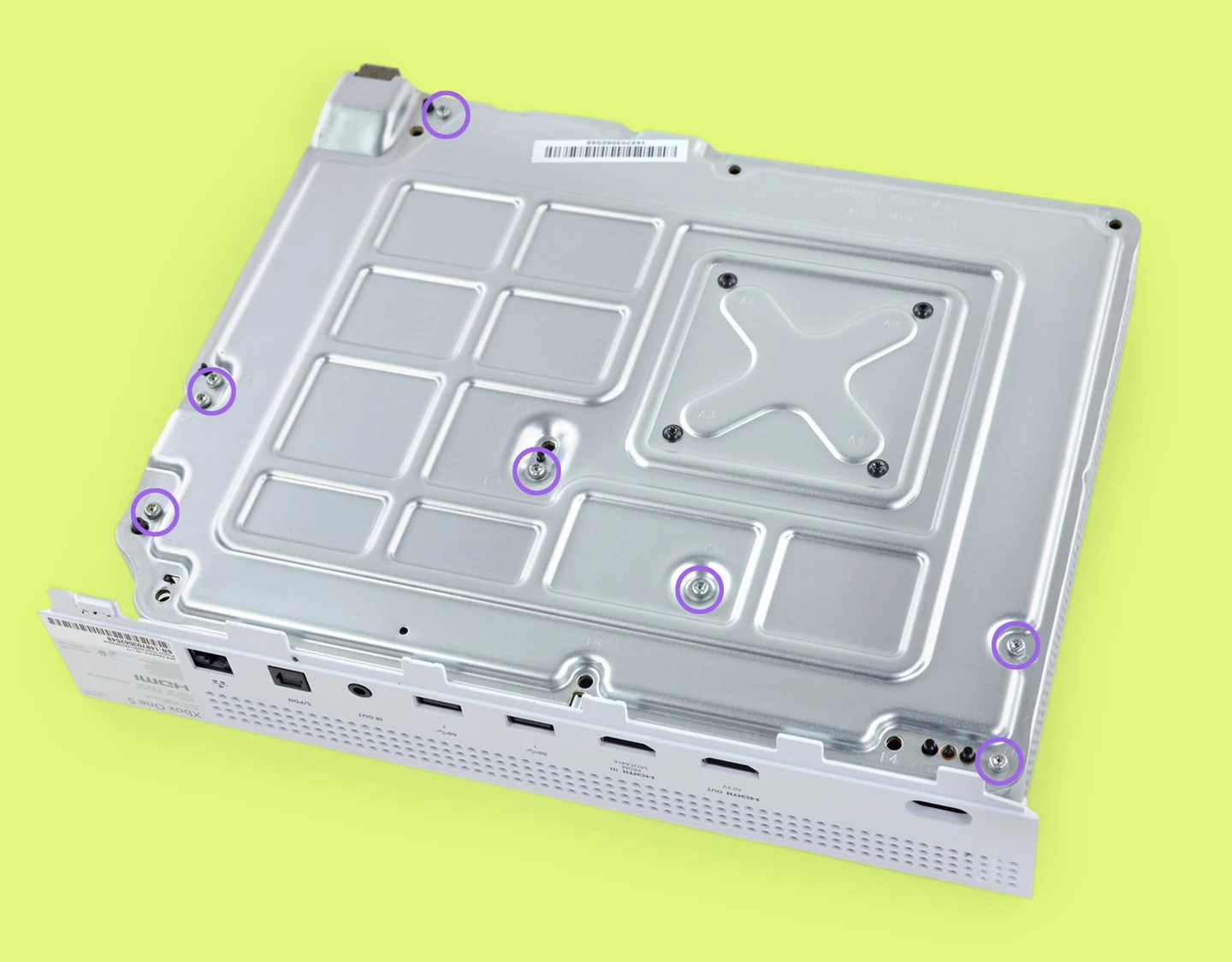 An Xbox One S internal chassis with the six green screws highlighted